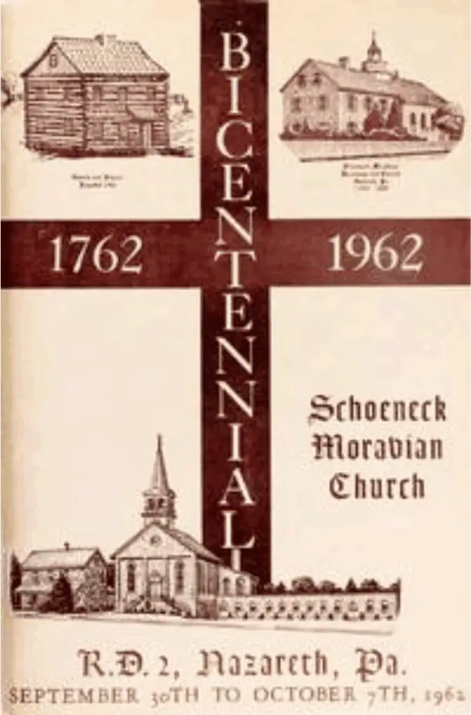 A photo of the book published in 1962 in celebration of Schoeneck's Bicentennial. In the top left corner is a drawing of the original log church with "Church and School, Founded 1762" written underneath. In the top right corner is a drawing of the 1793 stone church with "Schoeneck Moravian Parsonage and Church, Nazareth, PA, 1793-1888' written underneath it. In the center is a cross with "1762" on the left, "1962" on the right, and "Bicentennial" down the center. Underneath that is an drawing of the current stone parsonage and brick church with the Christian Education addition. Written underneath that image is "R.D. 2, Nazareth, PA. September 30th to October 7th, 1962." The cover is tan and the images and words are brown.