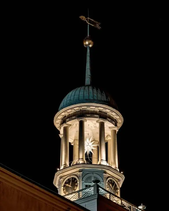 A white Moravian star shines brightly from the round bell tower of Central Moravian Church in Bethlehem, Pennsylvania.