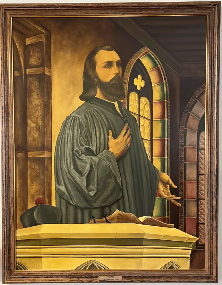 A painting of Jan Hus which hangs in the Narthex of Schoeneck Moravian Church. Hus stands defending himself at the Council of Constance, with his hand over his heart.