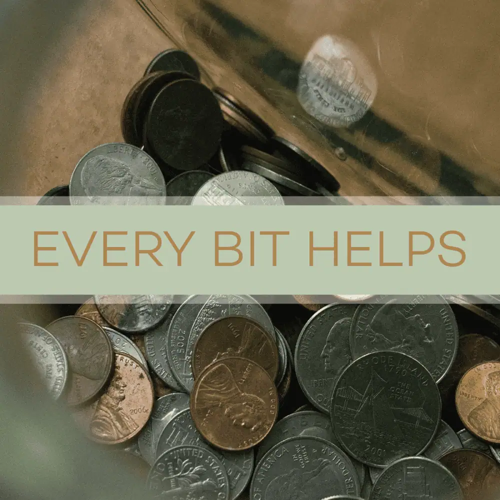 A close-up photo of different coins in a jar - pennies, nickels, dimes, and quarters are all mixed together. A pale green banner crosses the image with the words "Every Bit Helps" in copper colored lettering.