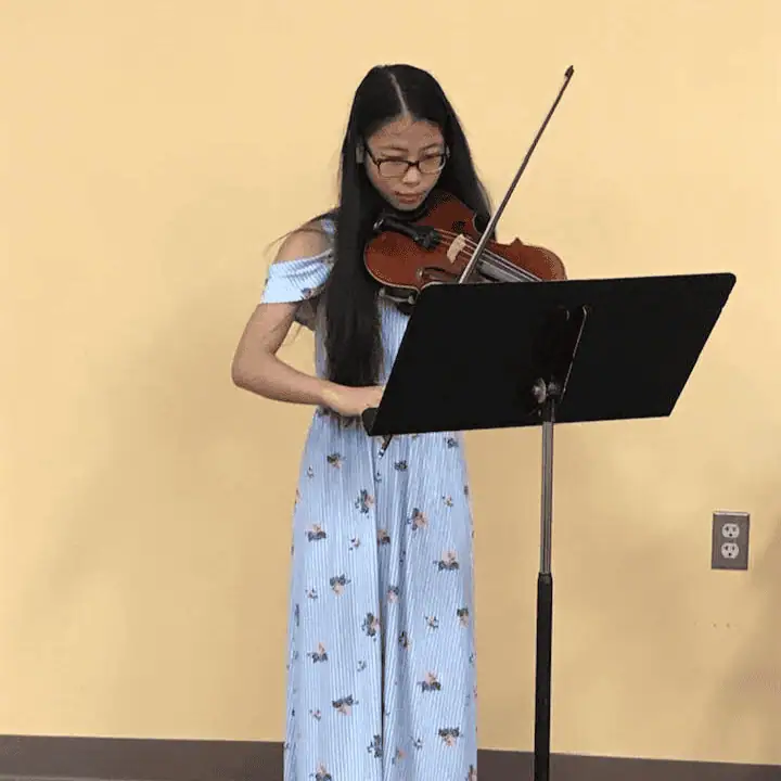 A teenage girl plays the violin in our fellowship hall.