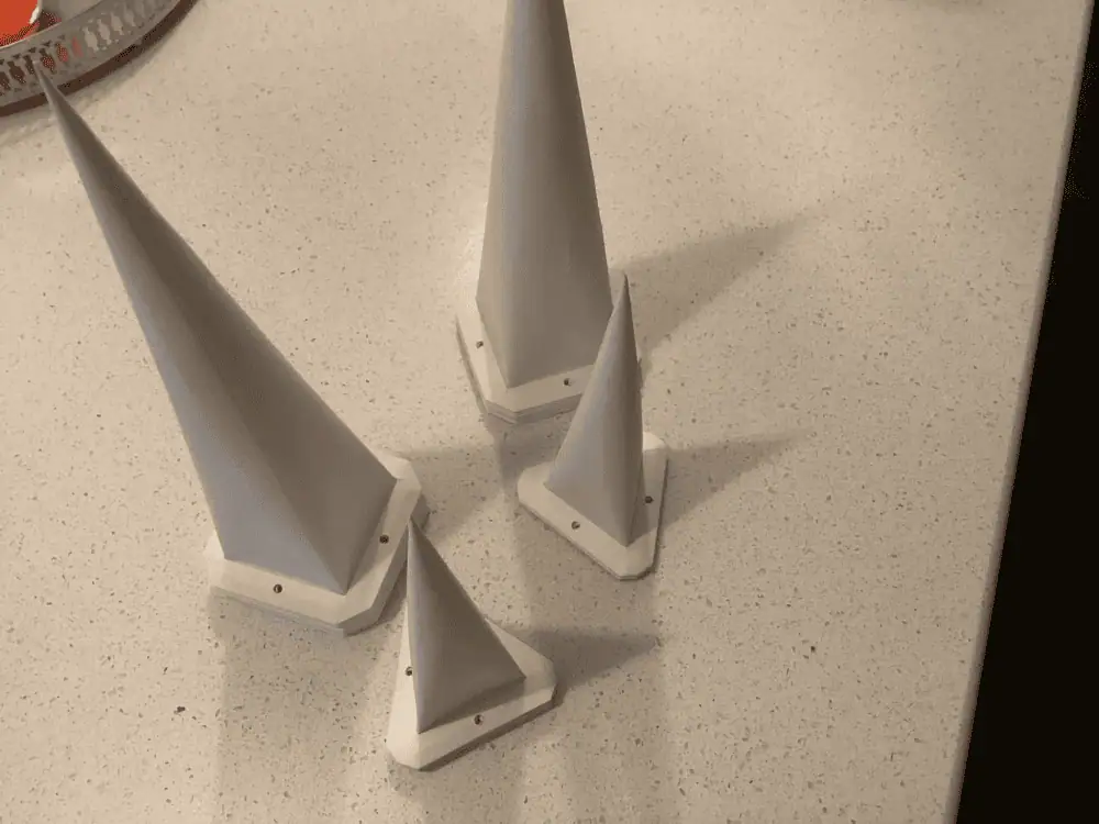 The pieces of a white paper Moravian star are stacked in four piles on a table.