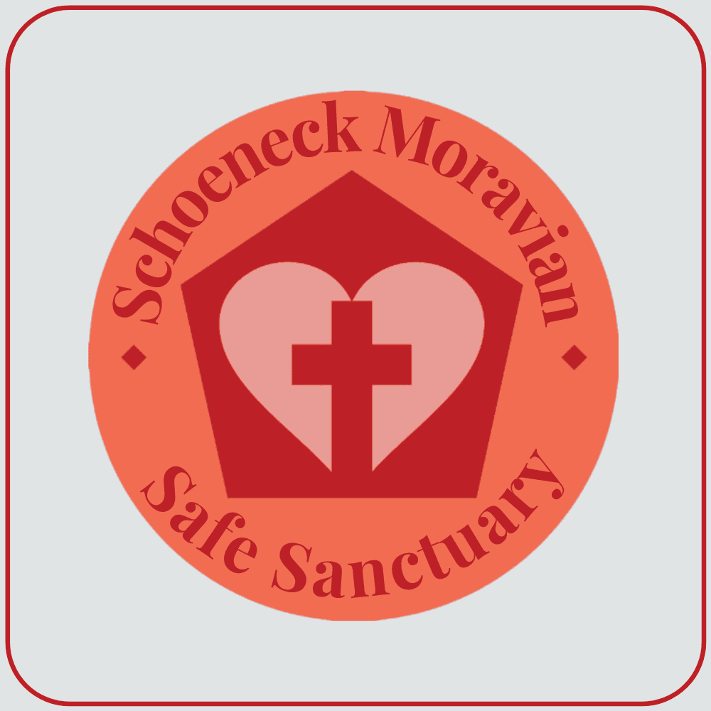 Inside a reddish-coral circle is dark red silhouette of a building. Inside the building shape is a pale pink heart with a dark red cross in the middle of it. The text surrounds the building, top and bottom, and reads "Schoeneck Moravian Safe Sanctuary".