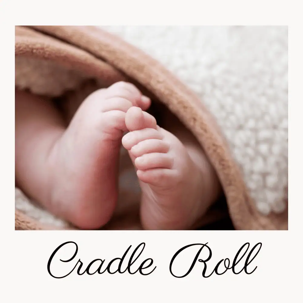 Little tiny baby feet peek out from under a blanket. Underneath the photo are the words, "Cradle Roll".
