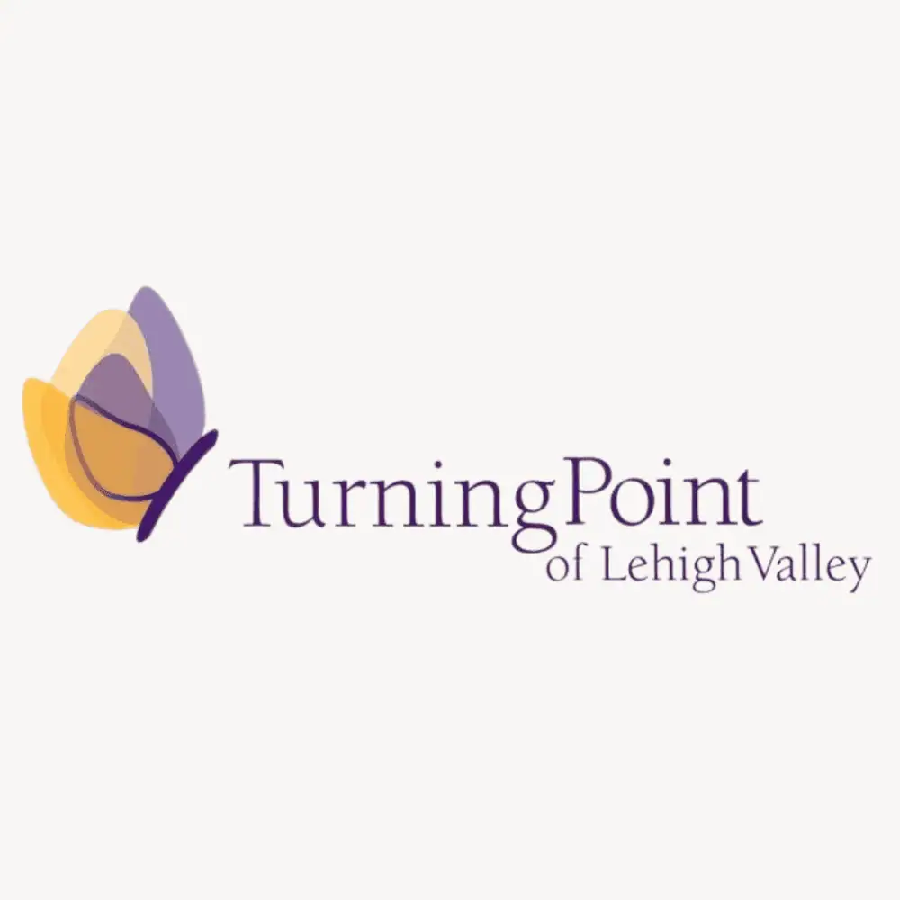 The logo for Turning Point for Women and Children featuring a butterfly in shades of lavender, light orange, and peach next to the words.