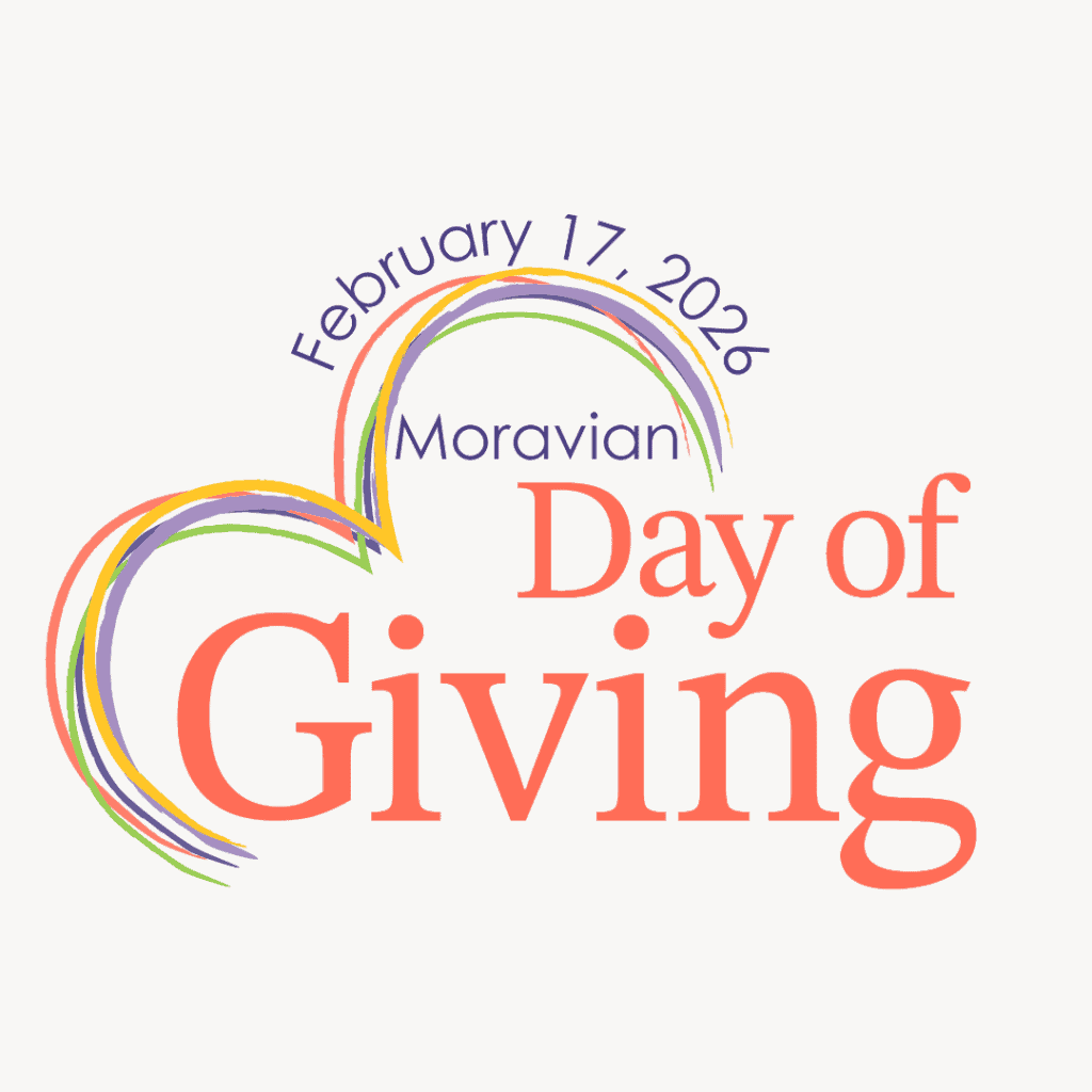 Logo for the 2026 Moravian Day of Giving. The date - February 26, 2026 - is written in a dark purple thin sans serif font. It curves above one half of the top of an angled heart. The heart is made of several lines in different colors - orange, golden yellow, bright lime green, dark purple, and light purple. The word Moravian is in the same thin sans serif font and dark purple color above the words Day of Giving, which are much larger, orange in color, and in a traditional serif font.